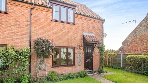 A brick house with a tiled roof, a front door, and a small garden area. - 3 bedroom accommodation in Ringstead, near Hunstanton (Ringstead, near Hunstanton)