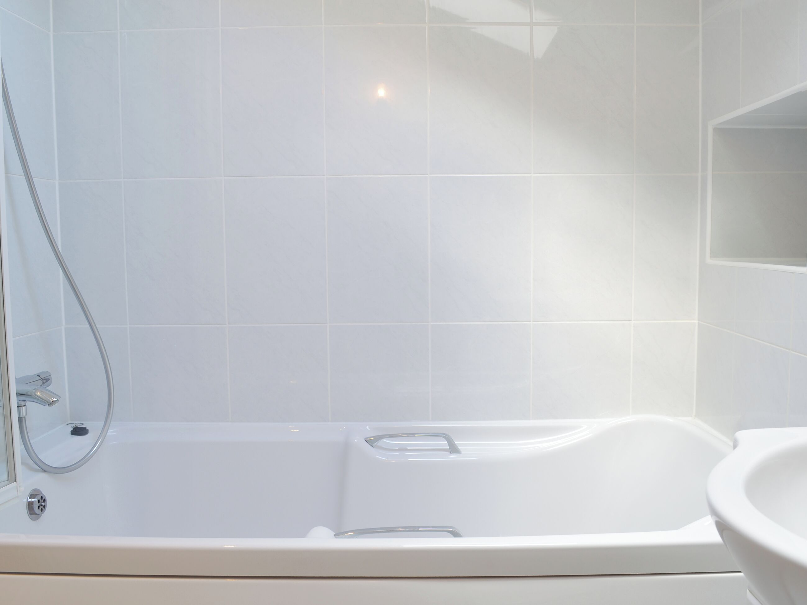 A bathroom with a bathtub, a shower, and a sink.