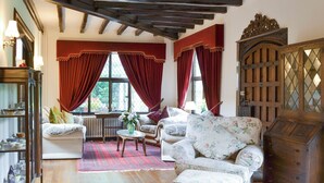 A traditional room with wooden floors, a sofa set, a radiator, and a wooden cabinet. - 3 bedroom accommodation in Little Chart, near Ashford (Little Chart, near Ashford)