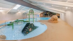 An indoor swimming pool with a slide, a rock formation, and a green archway. - 2 bedroom accommodation in Lelant, near St Ives (Lelant, near St Ives)