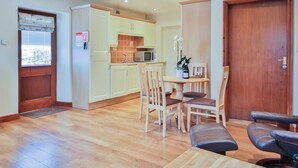 A compact living space with a kitchen, dining area, and a door leading to another room. - 1 bedroom accommodation in Sawley, near Clitheroe (Sawley, near Clitheroe)