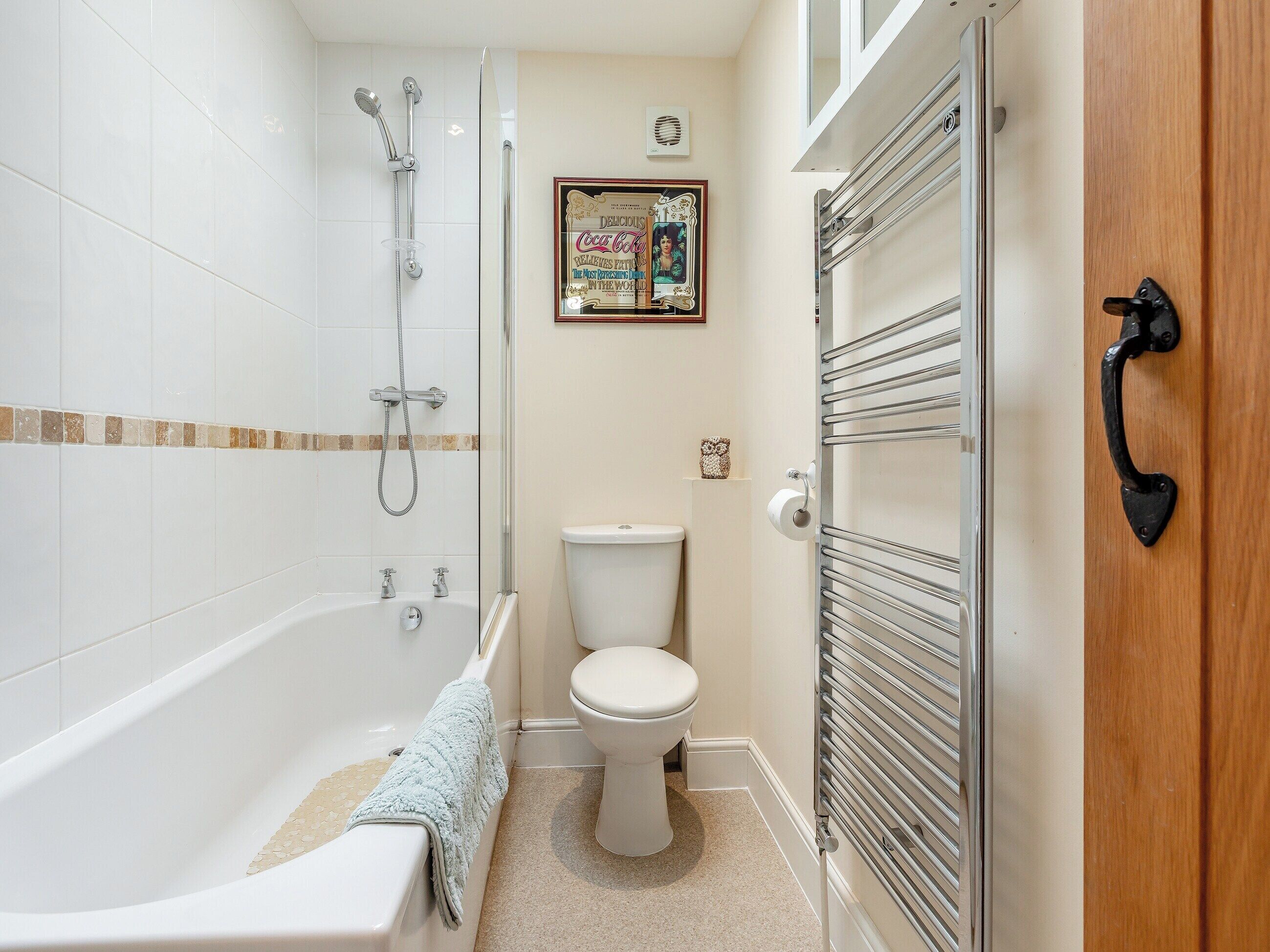 A bathroom with a bathtub, toilet, and shower.