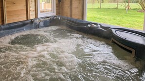 A wooden cabin with a hot tub. - 3 bedroom accommodation in Cutthorpe, near Chesterfield (Cutthorpe, near Chesterfield)
