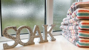 Decorative letters spelling "SOAK" and a stack of colorful towels. - 2 bedroom accommodation in Hulme End, near Hartington (Hulme End, near Hartington)