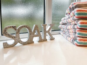 Decorative letters spelling "SOAK" and a stack of colorful towels. - 2 bedroom accommodation in Hulme End, near Hartington (Hulme End, near Hartington)