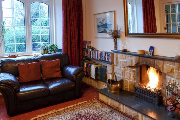 Comfortable living room with open fire | Culcharry Cottage, Cawdor, Nairn