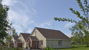 A row of two-story houses with a sloped roof, a brick foundation, and a small front yard. - 4 bedroom accommodation in Longhirst, near Morpeth (Longhirst, near Morpeth)