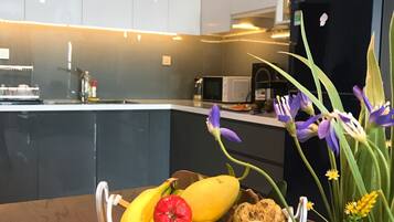 Apartment, 3 Bedrooms | Private kitchen | Fridge, microwave, rice cooker, cookware/dishes/utensils