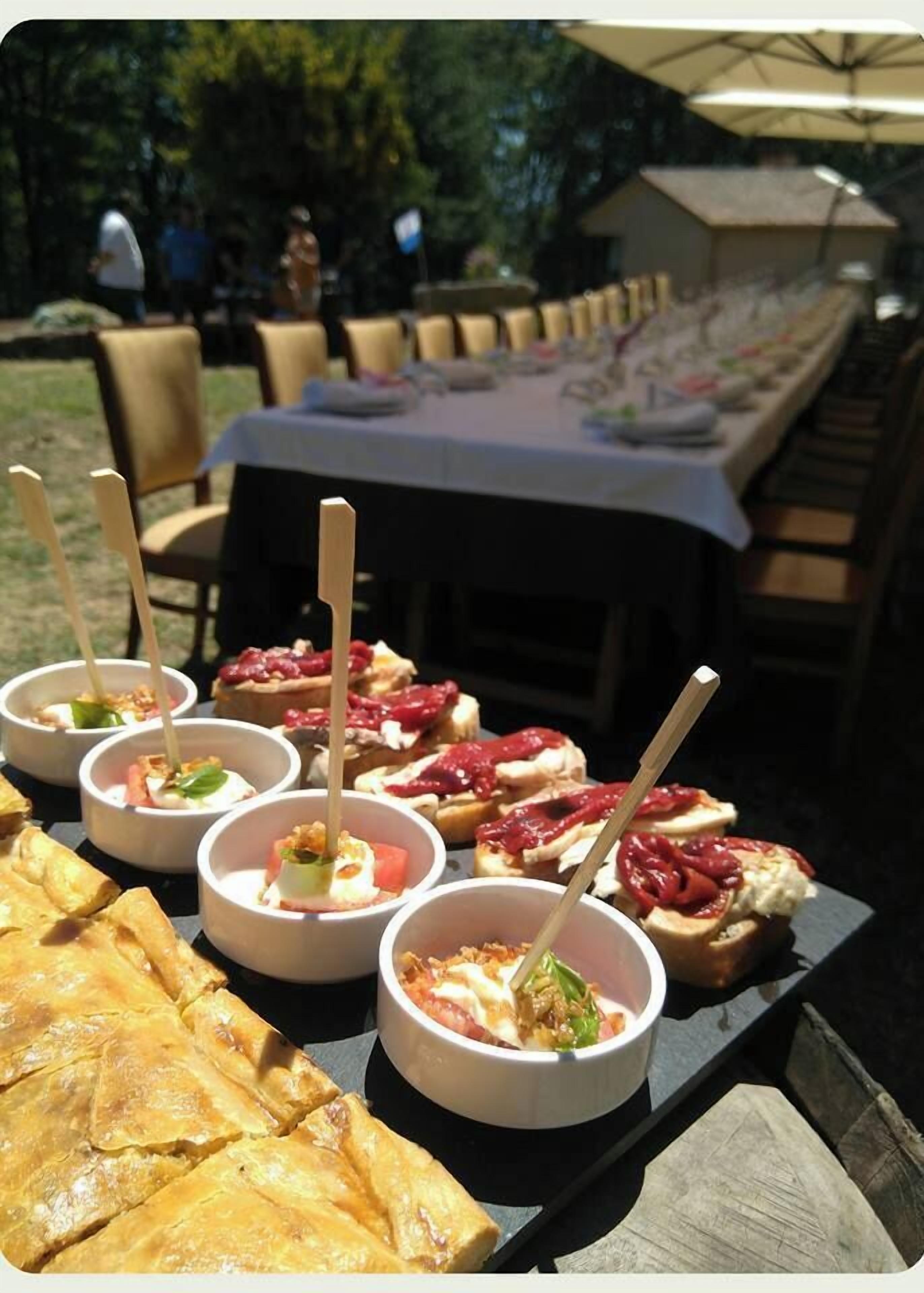 A table with food items and a view of a garden area.