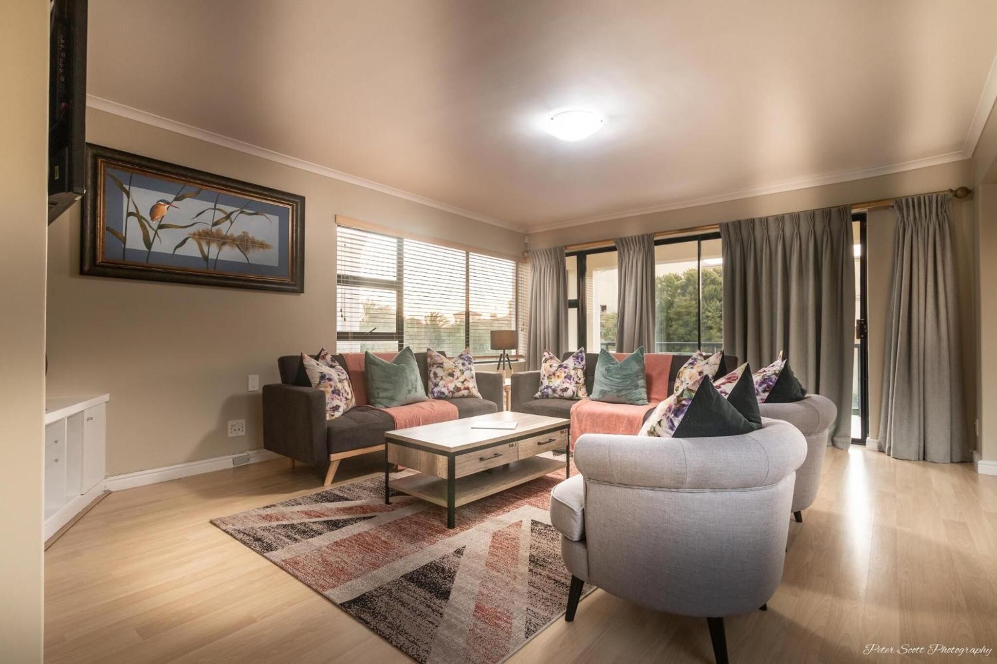 A living room with a sofa set, a coffee table, and a rug.
