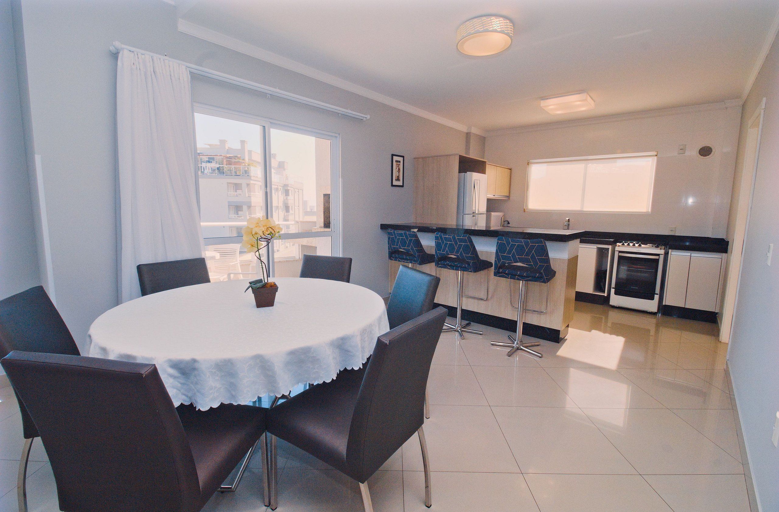 A modern kitchen with a dining area.