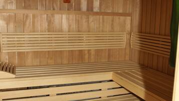 A sauna with wooden benches and a tiled floor.