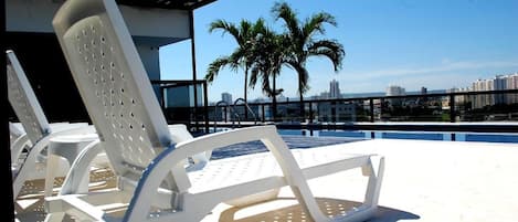 Outdoor pool, open 9:00 AM to 7:00 PM, pool loungers