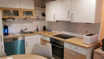 Comfort Apartment | Private kitchen | Full-sized fridge, microwave, oven, stovetop