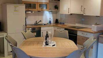 Comfort Apartment | Private kitchen | Full-size fridge, microwave, oven, stovetop
