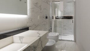 A modern bathroom with a marble vanity, a toilet, and a glass-enclosed shower. - Annunziata Guesthouse, Centro Storico (Naples)