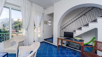 Deluxe Apartment, 3 Bedrooms | Living area | Flat-screen TV, fireplace