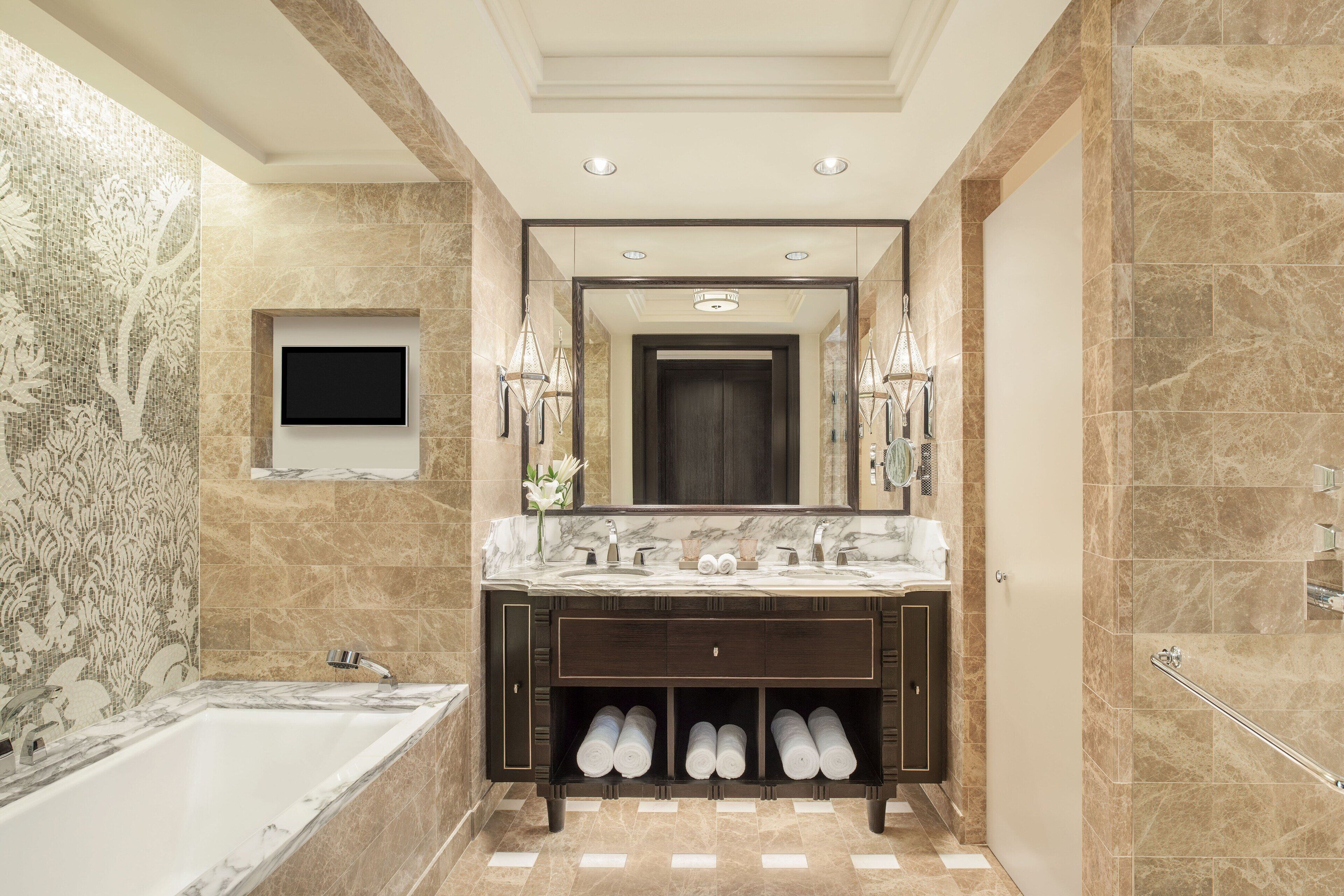 A modern bathroom with a marble vanity, a bathtub, and a walk-in shower.