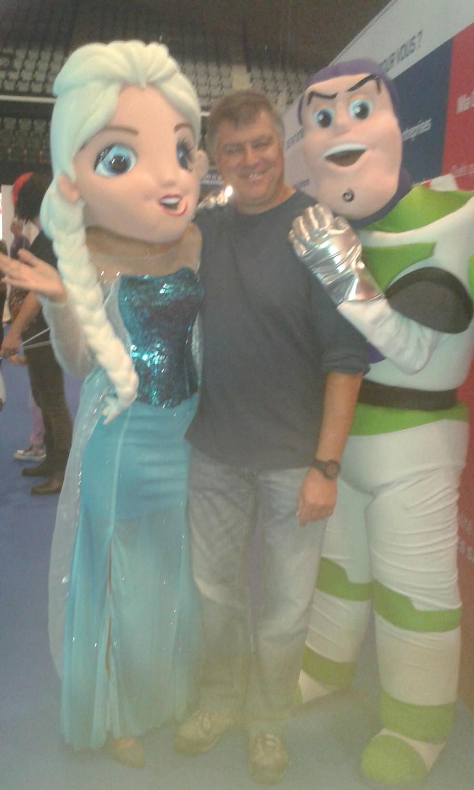 A person in a blue and white costume with a character in a green and white costume.