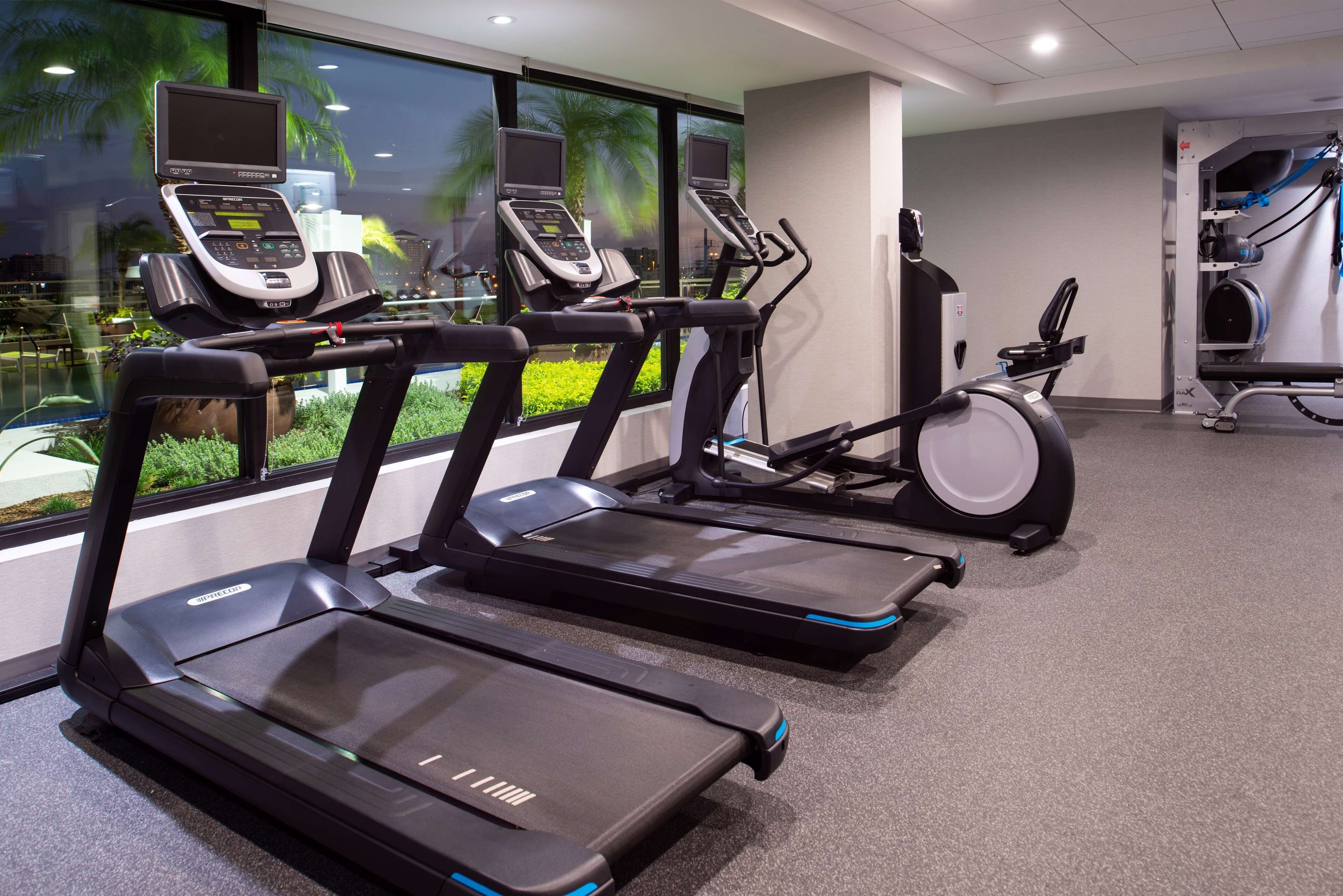A gym with treadmills, a stationary bike, and exercise equipment.