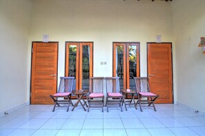 A room with four wooden doors, numbered 9 and 10, and two tables with chairs.