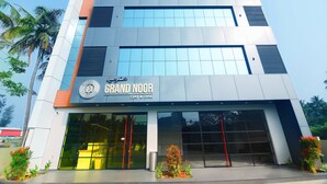 A modern hotel with a sign reading "Grand Noor Stay & Dine". - Noorjehans Grand Noor (Palakkad)