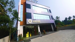 A modern building with a sign for 'Grand Noor' indicating it is a hotel and dining establishment. - Noorjehans Grand Noor (Palakkad)