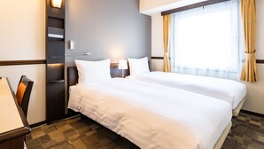 A hotel room with two beds, a desk with a lamp, a telephone, and a window with curtains. - Toyoko Inn Chubu International Airport No.2 (Tokoname)