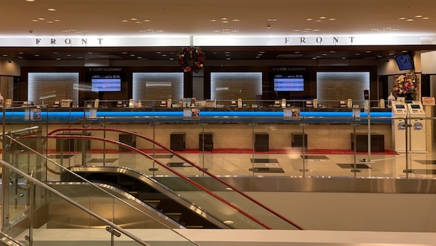 A modern hotel lobby with a reception desk, digital information screens, and a glass staircase. - Toyoko Inn Chubu International Airport No.2 (Tokoname)