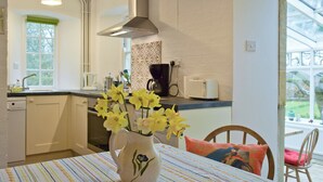 A kitchen with a window, a sink, and a vase with flowers on the table. - 3 bedroom accommodation in Church Enstone, near Chipping Norton (Church Enstone, near Chipping Norton)