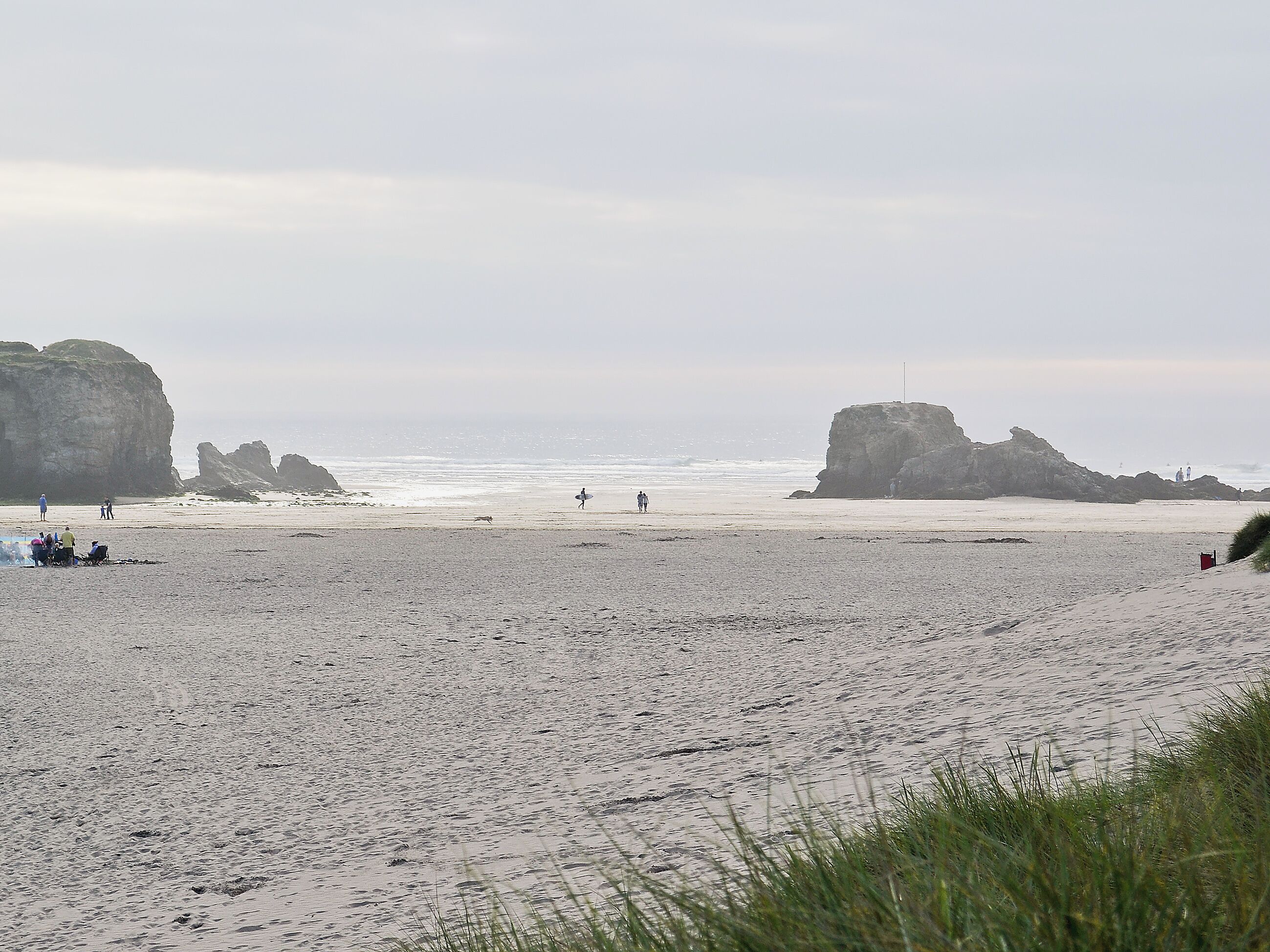 A beach with rocky formations and a clear view of the ocean.