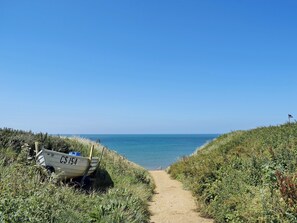 A narrow dirt path leading to a beach with a boat labeled "CS 15" on the left. - 1 bedroom accommodation in Brook, near Brighstone (Brook, near Brighstone)