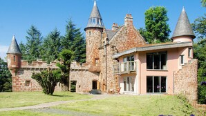 A castle-like building with multiple towers and a stone facade. - 4 bedroom accommodation in Largs (Largs)