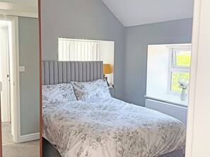 A bedroom with a bed, a window with blinds, a radiator, and a lamp. - 2 bedroom accommodation in Hamsterley, near Wolsingham (Hamsterley, near Wolsingham)