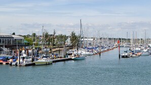 Un port de plaisance où de nombreux bateaux sont amarrés le long du quai.