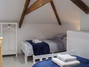 A bedroom with a bed, a wardrobe, and a hanging light fixture. - 2 bedroom accommodation in Boncath, near Cardigan (Boncath, near Cardigan)
