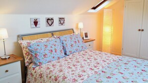 A bedroom with a bed, a nightstand, a lamp, a wardrobe, and a skylight. - 2 bedroom accommodation in Bowness-on-Windermere (Bowness-on-Windermere)