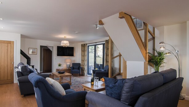A living room with a sofa, armchairs, a coffee table, and a TV. - The Coach House - UKC2772 (Sandwich Bay, near Sandwich)
