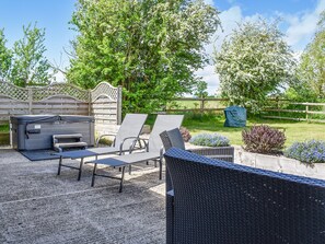 An outdoor patio with a grill, lounge chairs, and a garden area. - Sherwood Forest Lodge 1 (Kings Clipstone, near Mansfield)