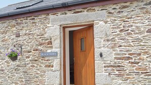 A stone building with a wooden door and a sign reading "BLACKTHORN". - 2 bedroom accommodation in Swan Pool, near Falmouth (Swan Pool, near Falmouth)