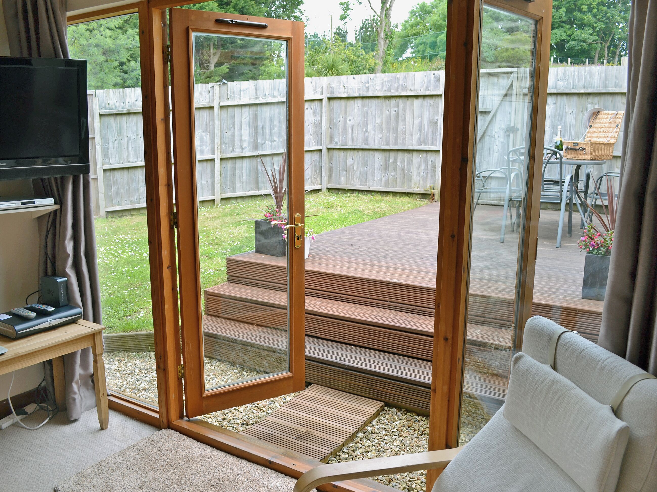 A modern living room with a sliding glass door leading to a patio.