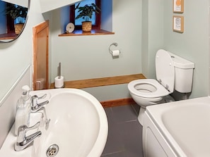 A bathroom with a sink, toilet, and bathtub.