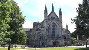 A large historic building with a prominent central tower and two smaller towers, surrounded by a well-maintained lawn and trees. - 1 bedroom accommodation in Burgate, near Fordingbridge (Burgate, near Fordingbridge)