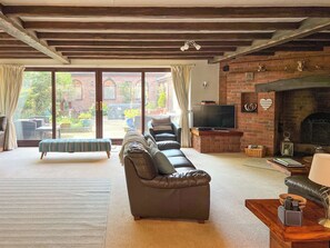 A living room with a sofa, a television, and a fireplace.