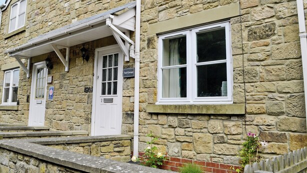 A stone building with a white door labeled "Teal Cottage." - 2 bedroom accommodation in Embleton, near Alnwick (Embleton, near Alnwick)
