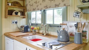 A kitchen with wooden countertops, a sink, a kettle, and a toaster. - 1 bedroom accommodation in Dippertown, near Tavistock (Dippertown, near Tavistock)