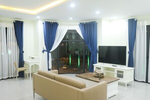 Family Suite Room (Ocean Harbor View & Riverfront) | Living room | Flat-screen TV - QB Casa Residence (Dong Hoi)