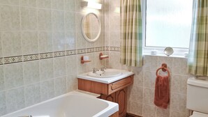 A bathroom with a bathtub, sink, and toilet.