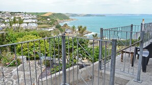 A coastal town with a view of the sea, a staircase with metal railings, and a stone pathway. - 1 bedroom accommodation in Mevagissey, near St Austell (Mevagissey, near St Austell)