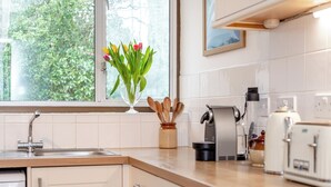 A kitchen with a window, a sink, a coffee maker, and a toaster. - 4 bedroom accommodation in South Tehidy, near Portreath (South Tehidy, near Portreath)